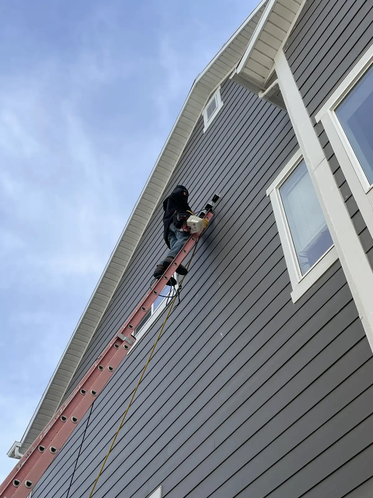 Technician Ladder Siding Exterior provided by Air Pro UT.