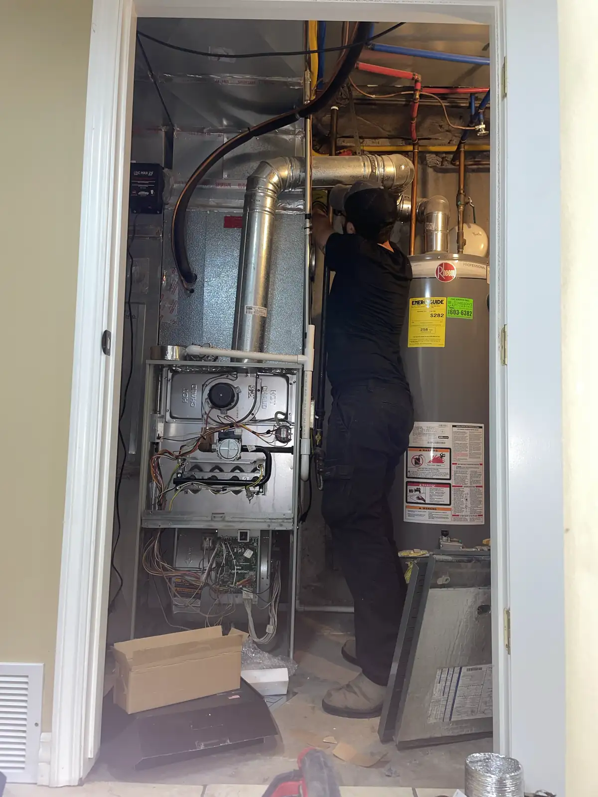 Technician Servicing Furnace Room provided by Air Pro UT.